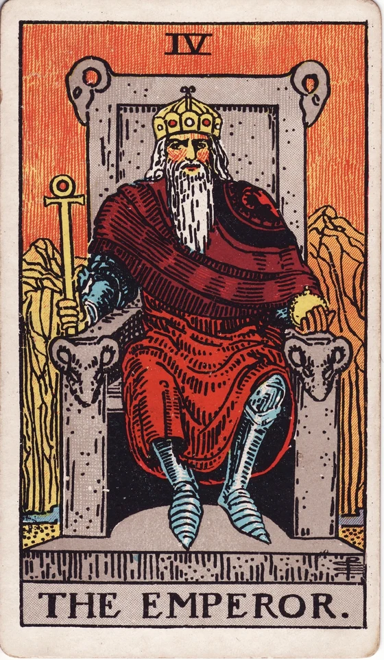 The Emperor tarot card from the Rider–Waite–Smith deck: a bearded ruler in armour and red robe on a stone throne decorated with ram heads, barren mountains behind him.